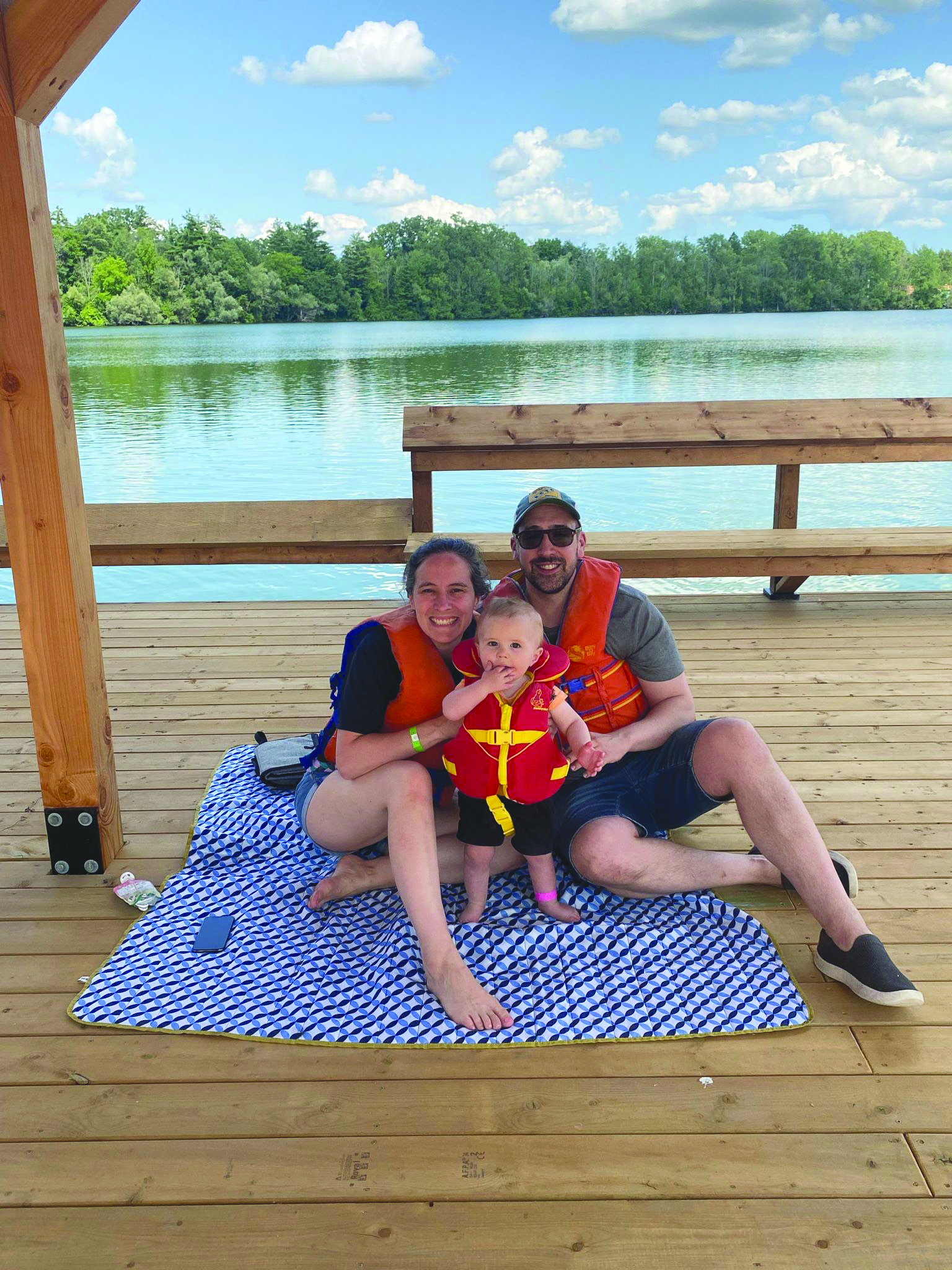will and his family sitting on the dock at camp