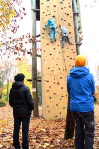 rock wall with campers climbing under supervision