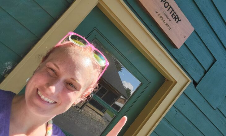 vanessa pointing to pottery sign