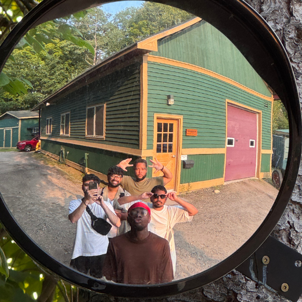 staff and volunteers taking a picture of themselves in a mirror