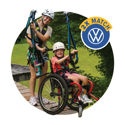 camper and counsellor on accessible ropes course in safety gear