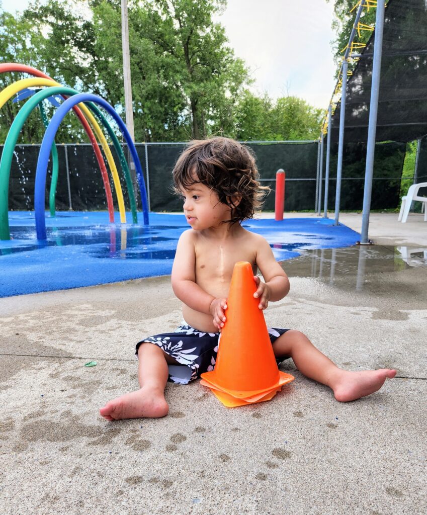 camper on the splash pad at rainbow lake