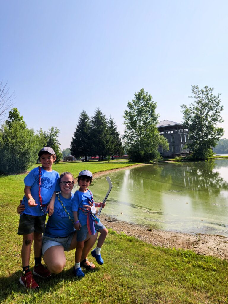 family standing by the water at rainbow lake on a sunny day