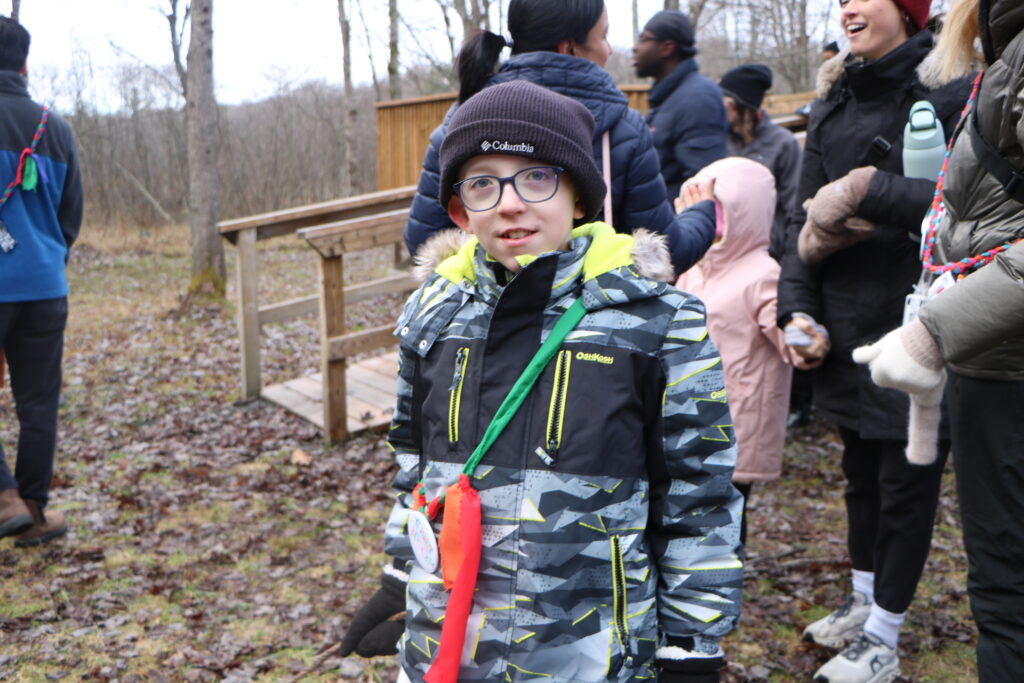 brock outside at camp on a fall day with other counsellors and campers