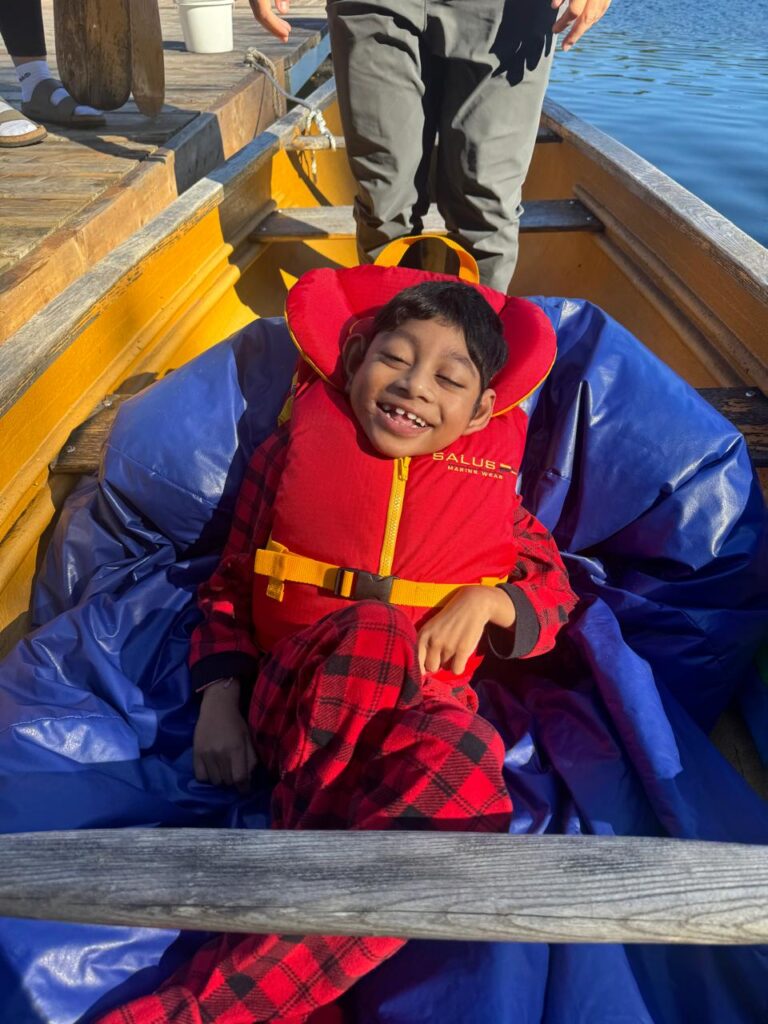 muhammad, smiling wearing a lifejacket on a canoe