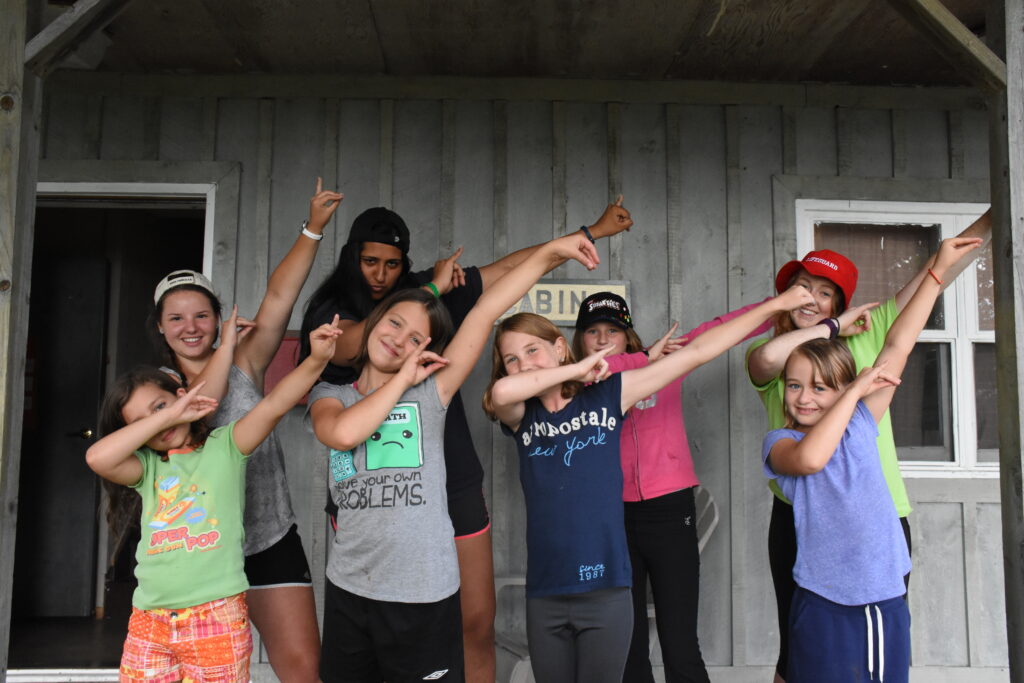 kiran and campers holding out arms to the left