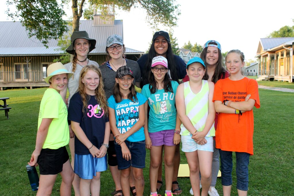 kiran and campers together outside with cabins in background
