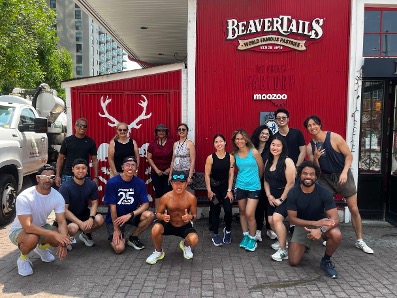 telus sporting life 10k team in front of beaver tails