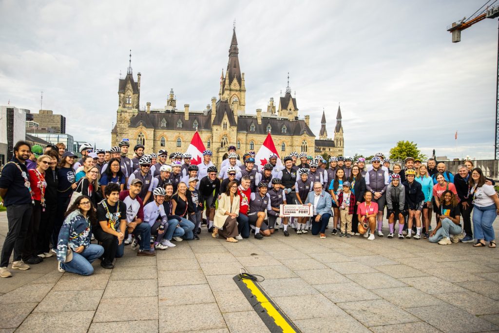riders and community members gathered in front of parliament hill