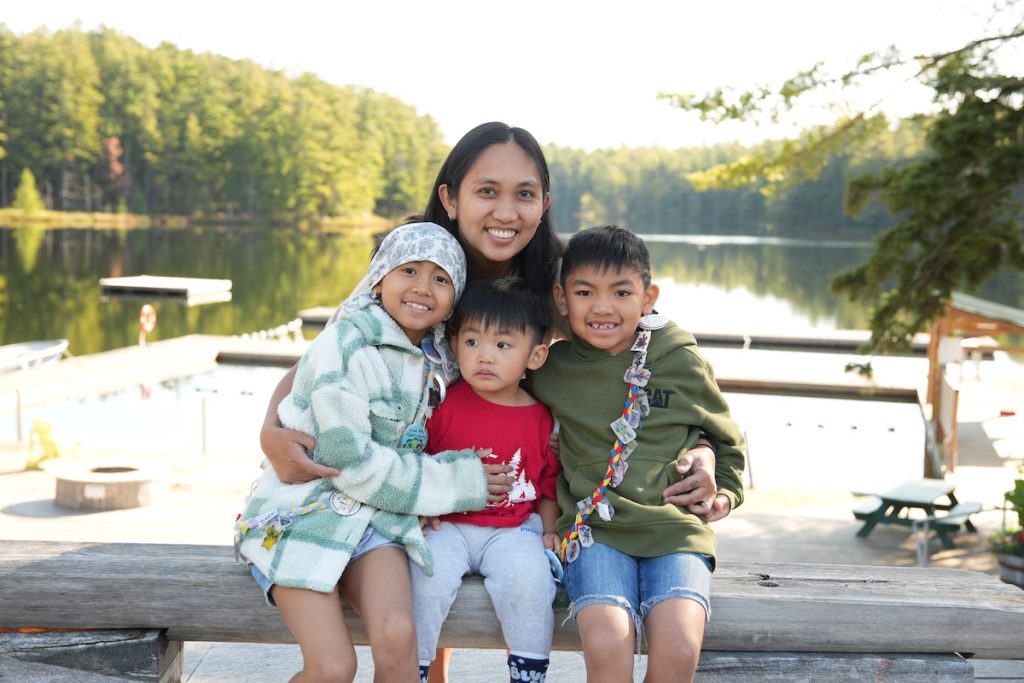 kursten with her family in front of the lake at camp