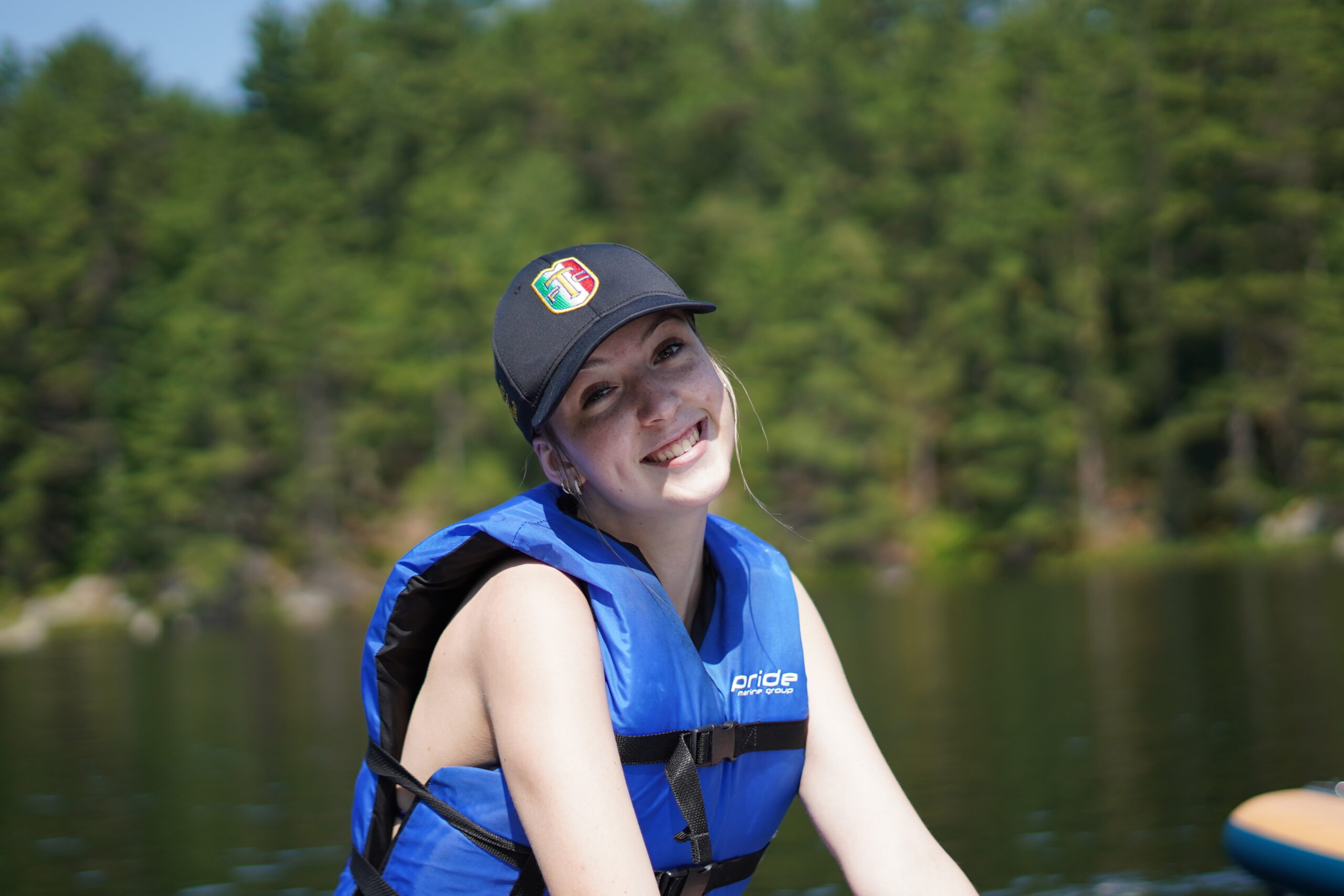 angelina wearing a lifejacket on the water at camp