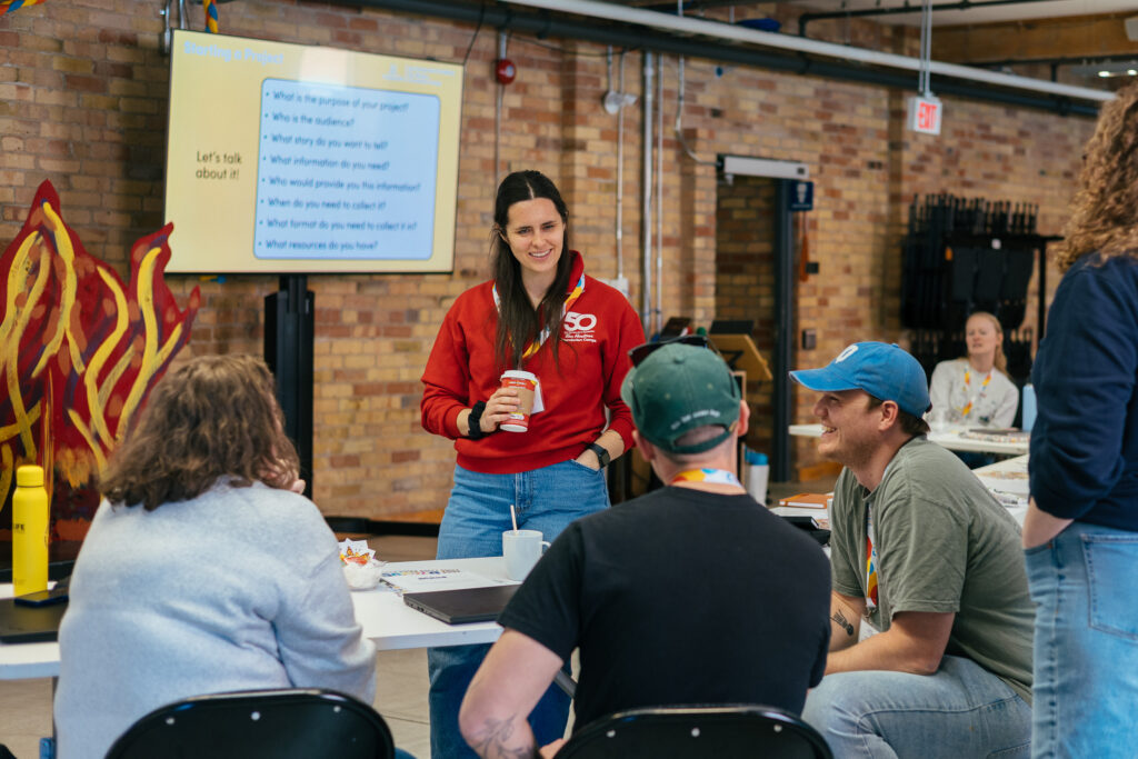 speaker and participants of the medical camps summit engaged in conversation