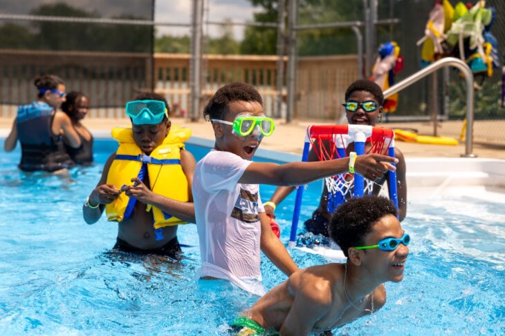campers in the pool at camp