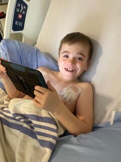 emerson in the hospital holding a tablet