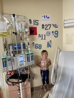 emerson standing next to a wall in his hospital room