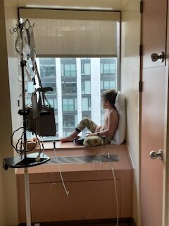 emerson sitting by the window in his hospital room