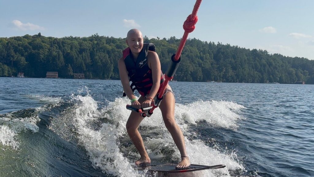 camper waterskiing at camp
