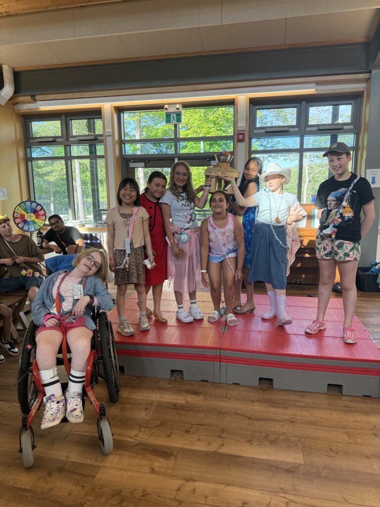 radda and campers on the dining hall stage at camp