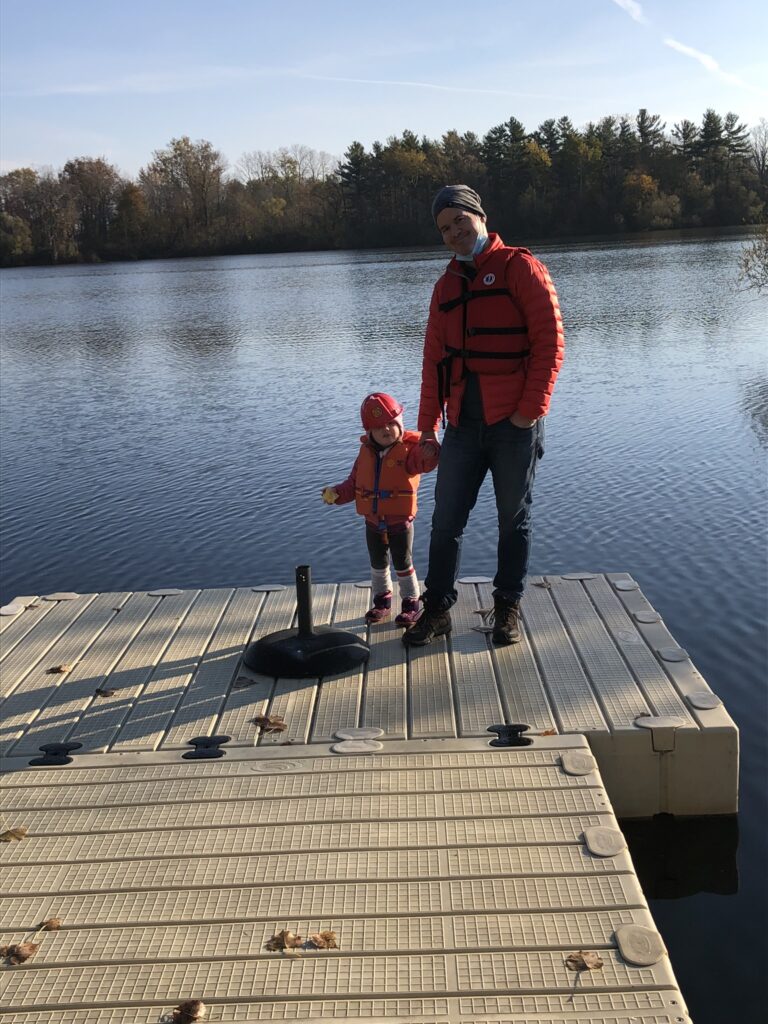 father and child on dock at camp
