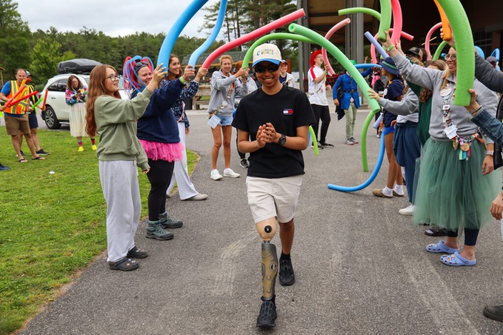 camper arriving at camp through pool noodle tunnel