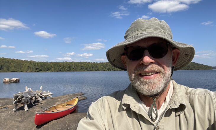 michael on the beach with canoe in background