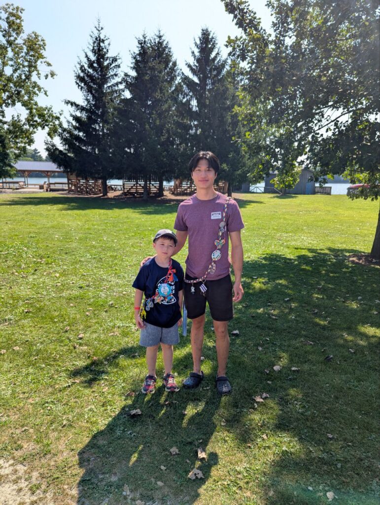 ben with his counsellor outside at camp