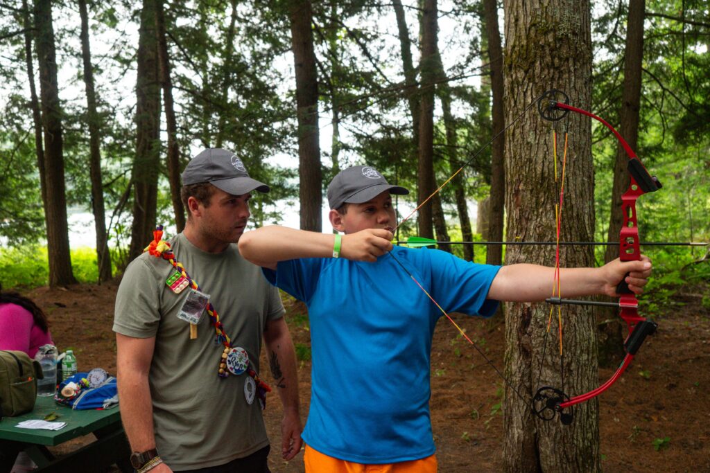 ollie at archery with volunteer