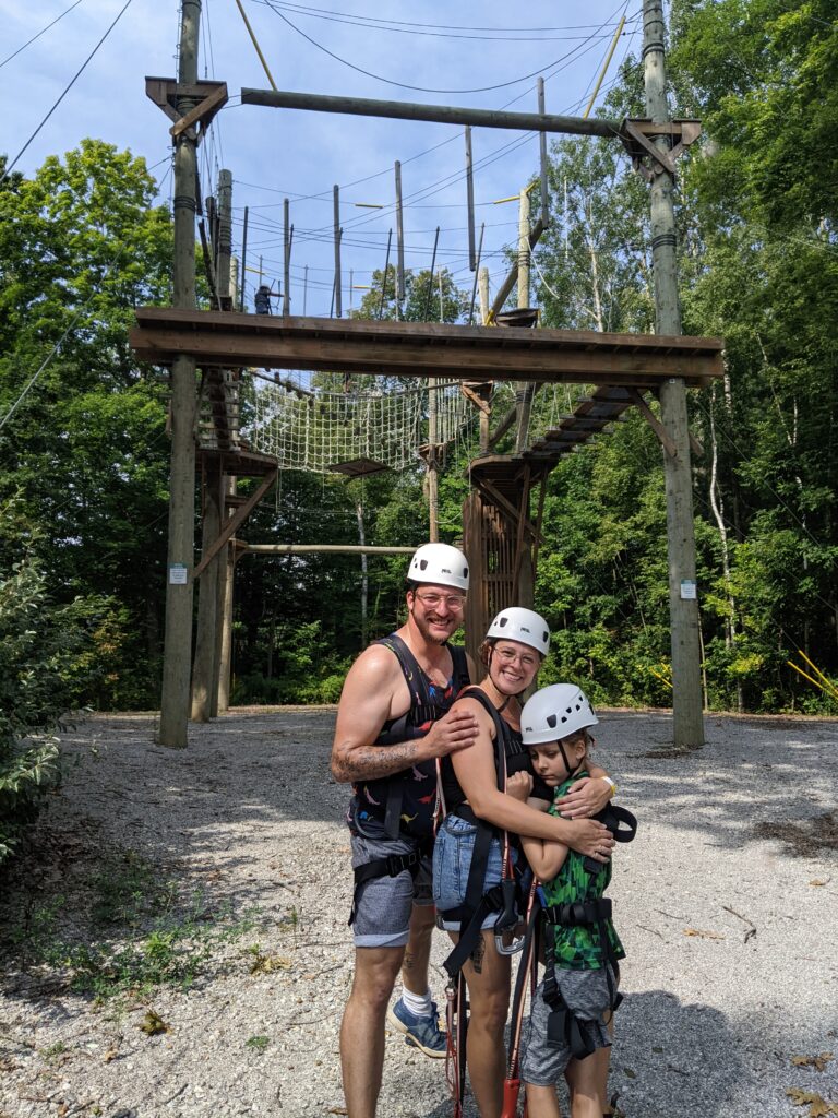 zack and his parents at the high ropes course at camp