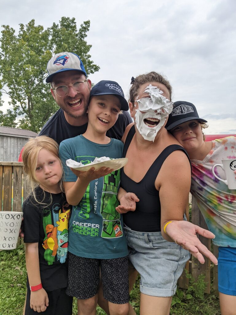 zack and his family at camp with a pie