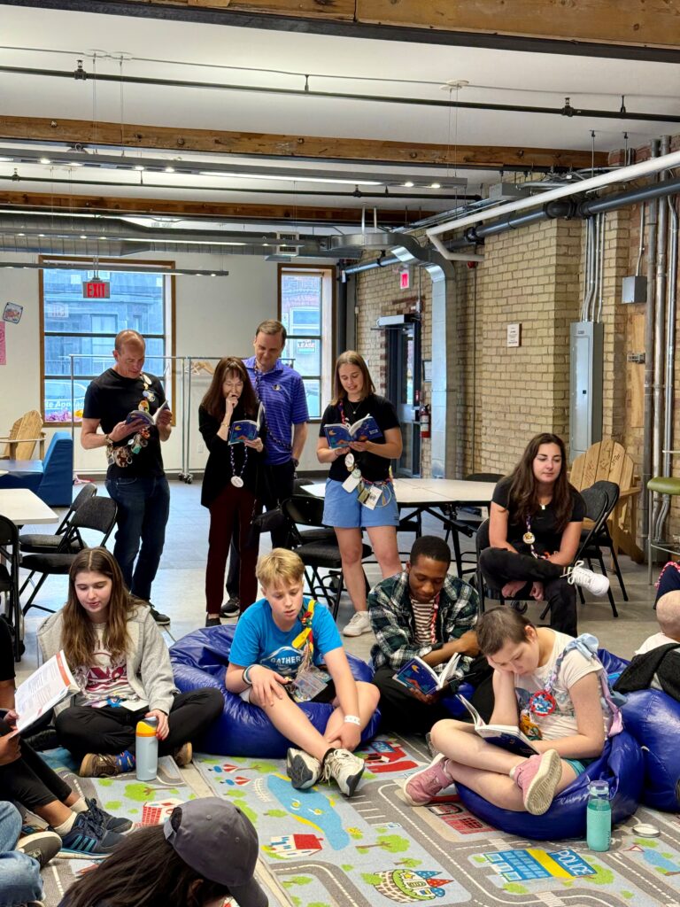 priscilla singing with campers, staff and volunteers