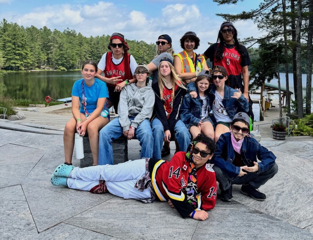 volunteers in front of the lake with trees in the background