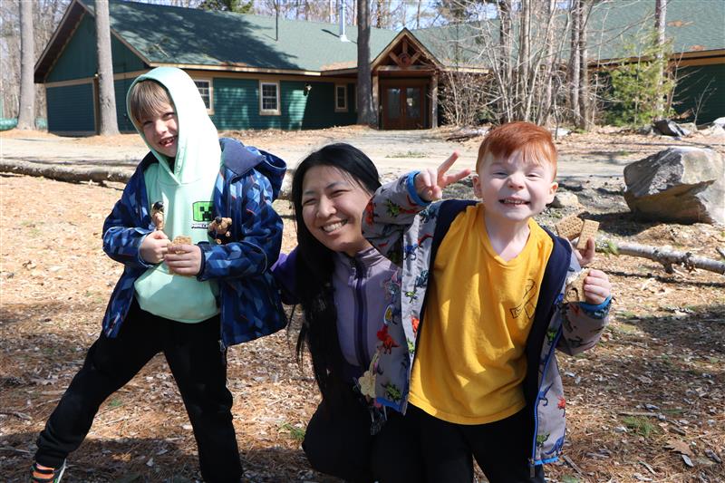 volunteer with campers outside on a fall day at camp