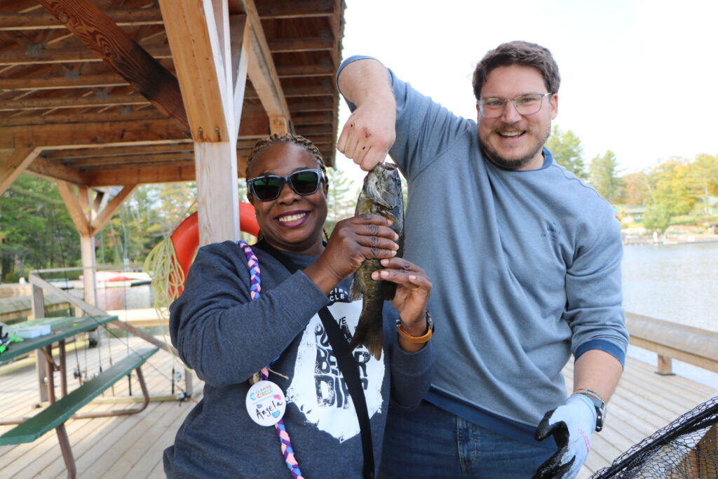 volunteers holding up a fish