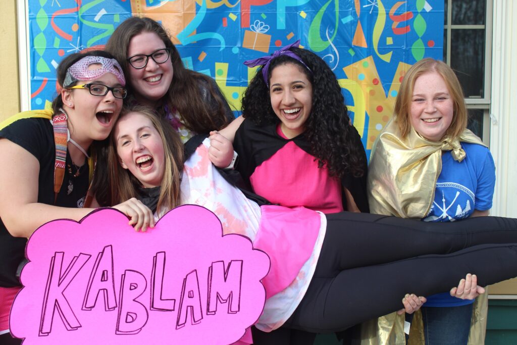 maram with other volunteers holding a pink sign