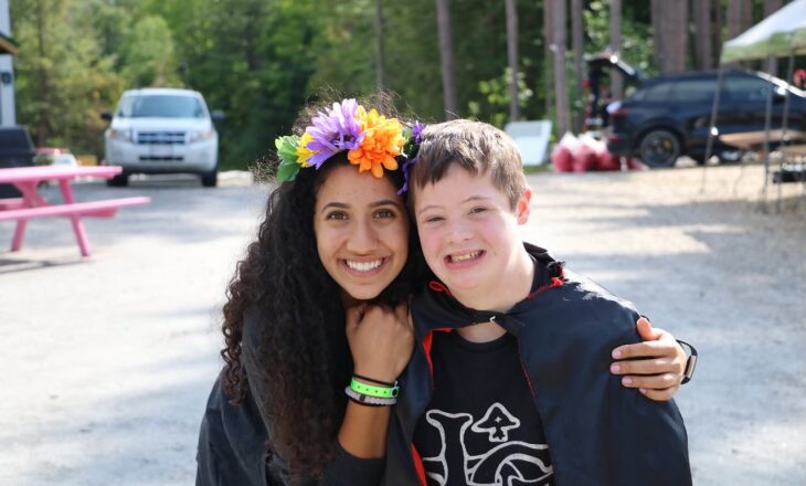maram with camper outside at camp